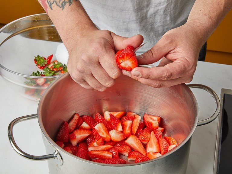 Place a small plate in the freezer. Wash the strawberries and cut them into quarters. In a large pot, combine the jam sugar and strawberries, stirring until well combined. Let that sit for approx. 1 hr.