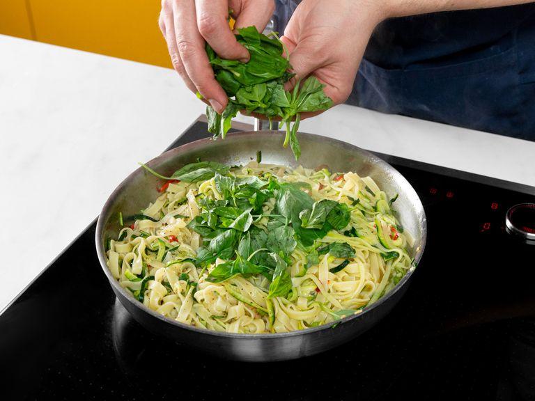 Add cooked pasta to the frying pan and toss. Add the pasta cooking water and let simmer until the pasta is al dente. Add lemon juice and basil, then season with salt and pepper to taste.