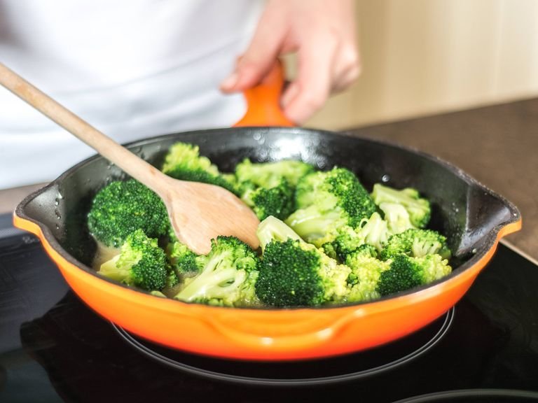 Next, toss the blanched broccoli in the buttery stock. Season with salt and pepper if desired. Serve the halibut on the broccoli and garnish with almond flakes.