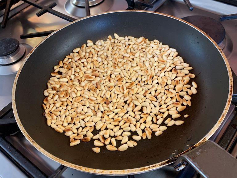 Toast the pine nuts in a pan until brown
