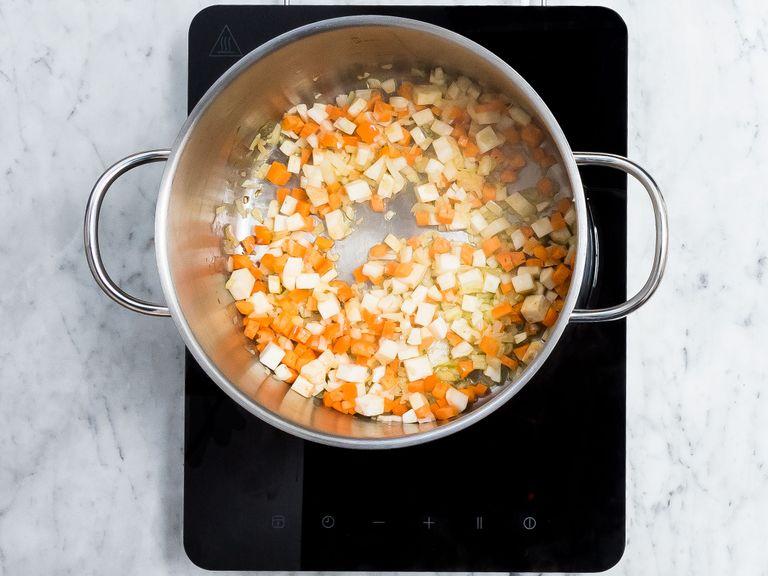 Peel and dice onion, carrot, parsley root, and celery root. Peel and finely crush garlic. In a large pot, heat olive oil over medium to high heat and add diced onion, carrot, parsley root, and celery. Sauté until golden brown, then add crushed garlic and sauté for 1 - 2 min. more.