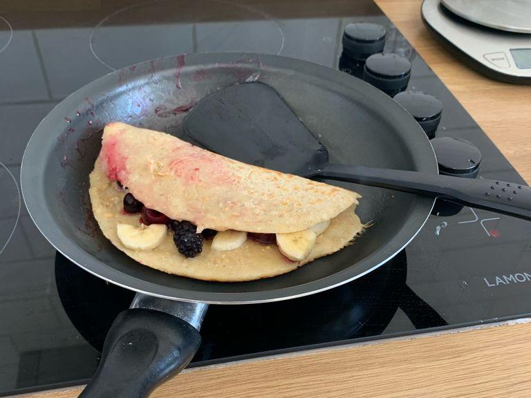 Once the bottom starts to colour fold the pancake. Continue to cook until all the filling is soft. Add more honey and yogurt