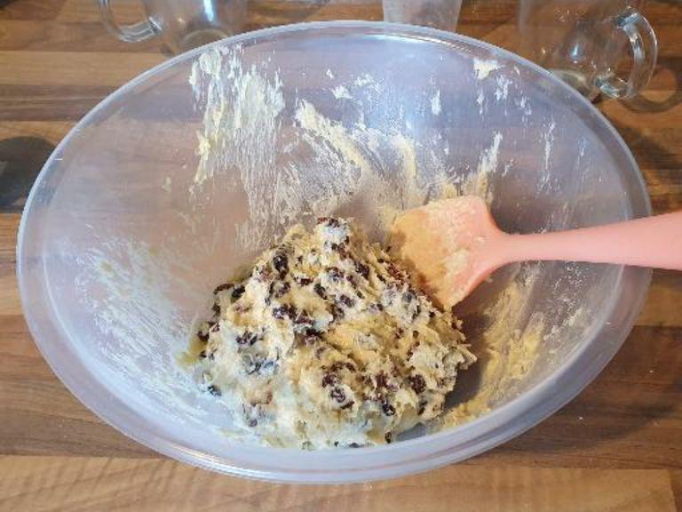 Add the sultanas or raisins. Mix this all together some more until the mixture is dough-like and use your hands.