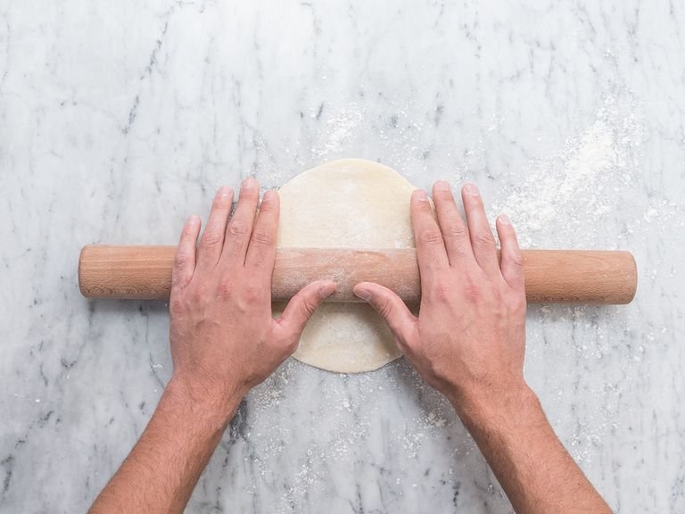 On a flour-dusted working surface, divide dough into equal-sized pieces. Using a rolling pin, roll each piece out into a 0.5 cm/0.25 in. round.