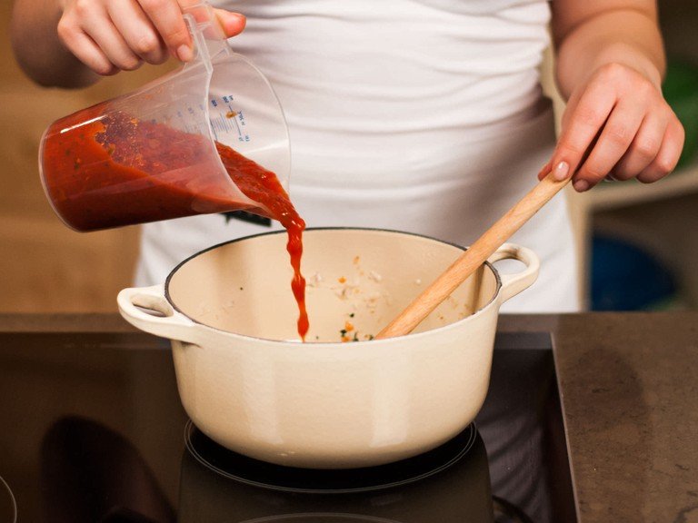 For the tomato sauce, heat up some vegetable oil in a saucepan and fry onion and garlic until transparent. Add oregano and tomatoes. Let simmer for 10 – 12 min. Season with sugar, salt, and pepper.