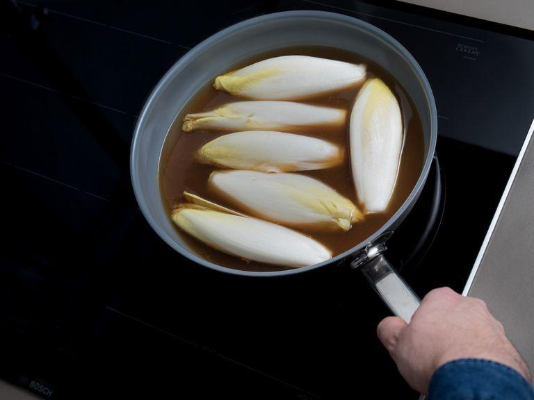 In a frying pan over medium heat, bring the vegetable broth and apple juice to a simmer. Add halved endives, cut side-down, reduce heat, and cook for approx. 8 min., or until tender. Remove them from the frying pan onto a paper towel-lined plate. Set aside and drain the frying pan.