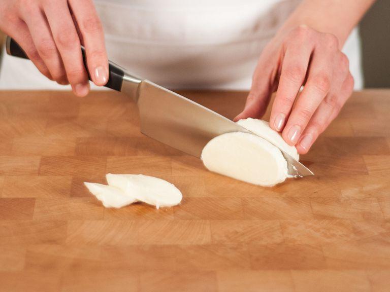 Cut mozzarella into slices approximately as thin as eggplant.