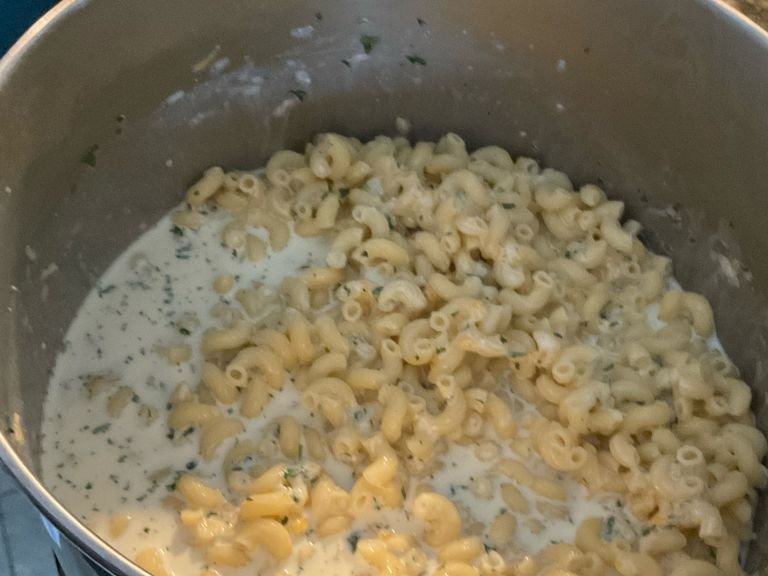 Place strained macaroni ￼into large bowl. Mix in cream, milk, flour, parsley leaves, salt, three quarters of the cheese mix, and pepper into the bowl and stir.￼