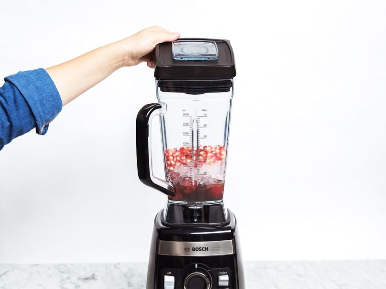 Add pomegranate juice, frozen strawberries, ice, and pomegranate seeds to the blender and blend to a smooth slush (using your blender's ice cream function). Serve with more lime zest on top and enjoy!