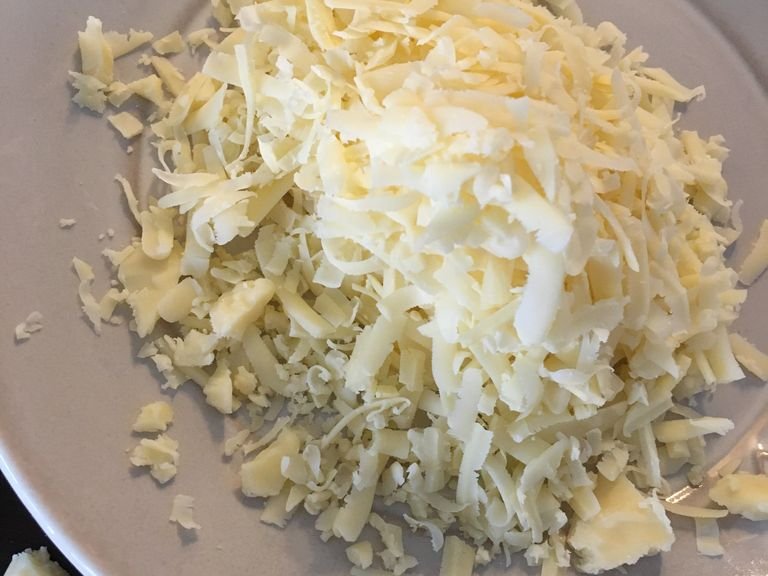 Add 2/3 of the cheddar and add all of the Parmesan.