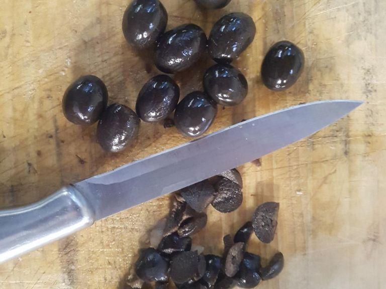 Remove black olive pits (be careful not to cut yourselves)