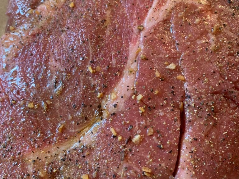 Remove the roast from packaging and rinse with cold water. Pat dry with a paper towel to remove any excess water. Drizzle both sides with EVOO and sprinkle your seasoning blend liberally over your roast. Set roast aside to do a quick marinade until it’s time to sear it.
