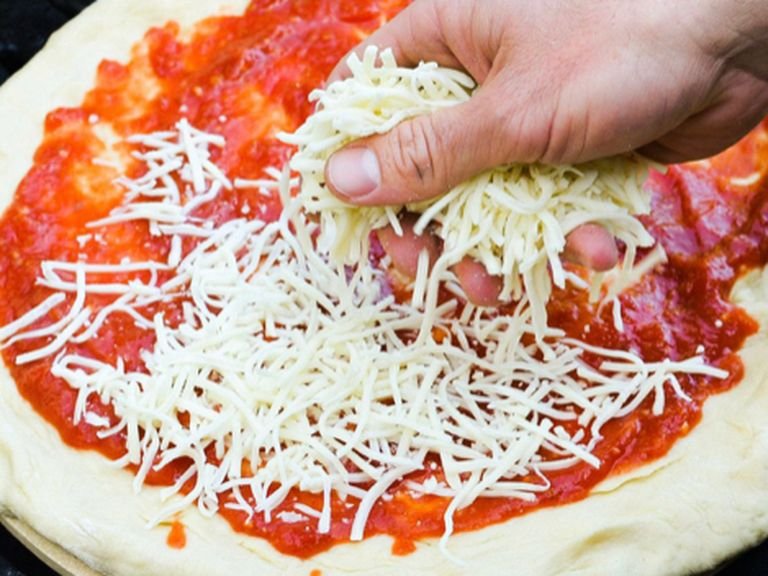 Preheat oven to 180 degrees. Take the dough out of the bowl and roll it into a thin circle. Transfer the circle to the mold and spread on the circle pizza sauce, do not forget not to put on the edges pizza sauce. Sprinkle with grated cheese on the pizza. If you want, you can also add toppings to the pizza. Brush a scrambled egg on the edges of the pizza. Put the oven on for fifteen minutes. Appetite!
