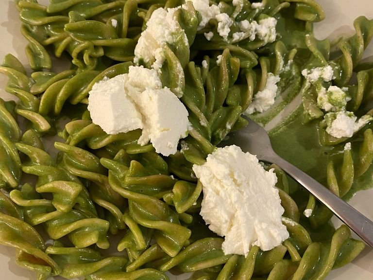 Put the pasta on a plate with some of the ricotta cheese on top.