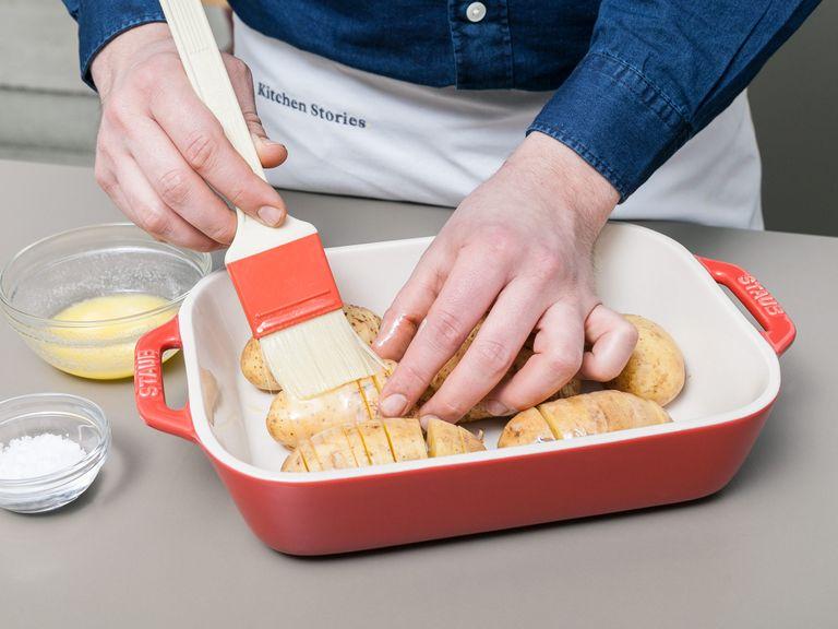 Melt butter in microwave. Brush half of the butter on the potatoes, sprinkle with sea salt, and place into a baking dish. Bake the potatoes in at 180°C/360°F for approx. 30 min.