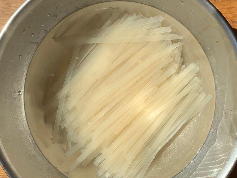 Add rice noodles to a bowl of warm water and set aside.