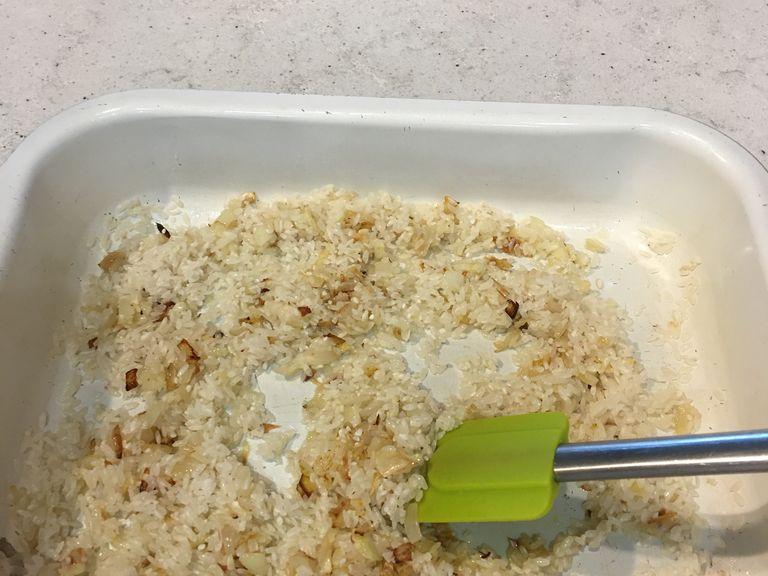 Remove the dish from the oven. Then wash your rice 2-3 times. Add the washed rice to the dish and mix thoroughly. Return the dish to the oven for about 10 mins or until the rice is almost translucent. If it’s too dry add an additional tbsp of olive oil.