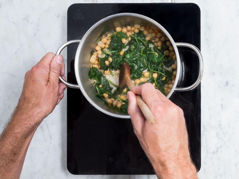 In the small pot, bring reserved chickpeas and cooking liquid to a boil and add spinach. Season with salt, pepper, and cumin. Let simmer until the spinach wilts, stirring occasionally. Serve hummus soup with chickpea-spinach mixture. Enjoy!