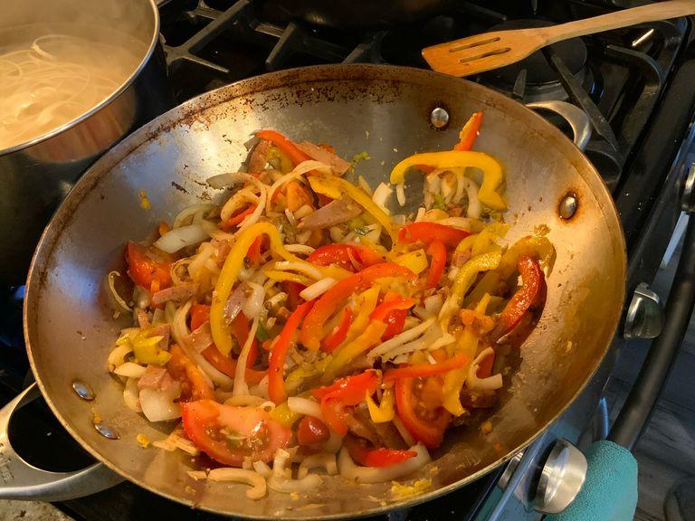 Put the sliced vegetables except bok choy in the wok for four minutes.