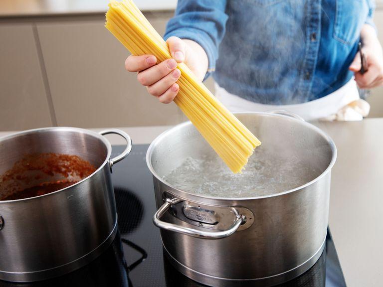 Währenddessen einen Topf mit Wasser zum Kochen bringen. Salz und Spaghetti in den Topf geben und nach Packungsanleitung al dente kochen.
