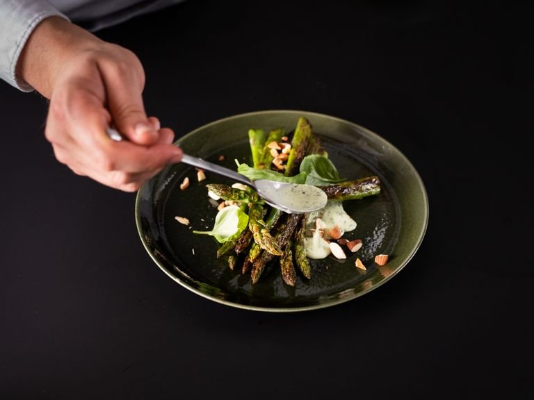 Stir lemon juice and zest into the dressing. Spread the basil dressing on a plate and place the charred asparagus on top. Garnish with toasted almonds and remaining fresh basil leaves. Enjoy!