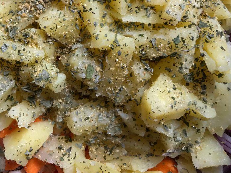 Chop the potatoes and add it to the rest of vegetables. Mix it with olive oil, salt and oregano.