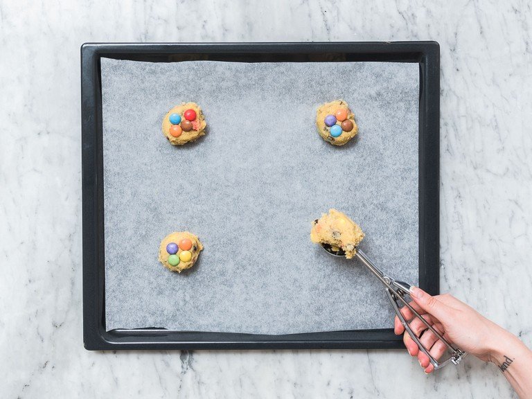 Using an ice cream scoop to portion the dough and transfer dough balls onto a parchment-lined baking sheet, leaving enough space for each cookie. Best is to place not more than 4 – 6 cookies on a baking sheet. Press some M&M’s onto each cookie and bake at 175°C/350°F for approx. 12 min., or until just golden. Remove from oven and let cool completely. Store them in an airtight container and enjoy!
