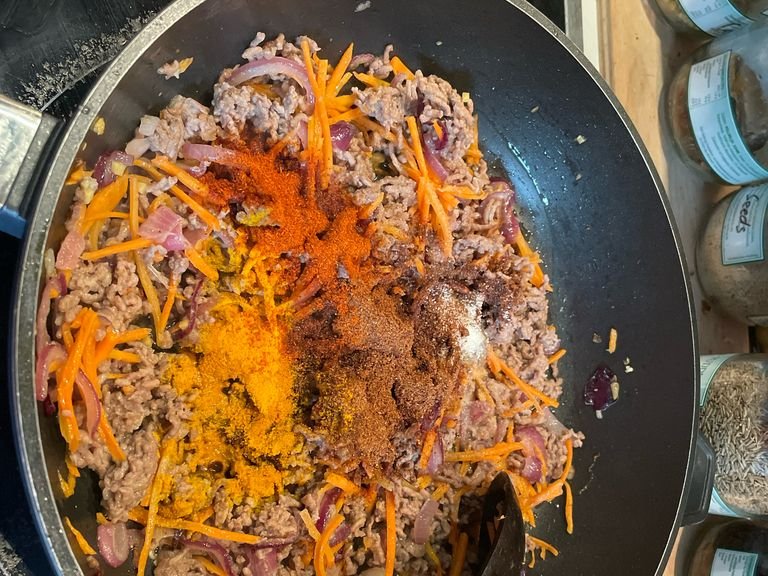 Add garam masala, turmeric, cayenne pepper and salt. Mix gently and allow spices to blend into the meat.