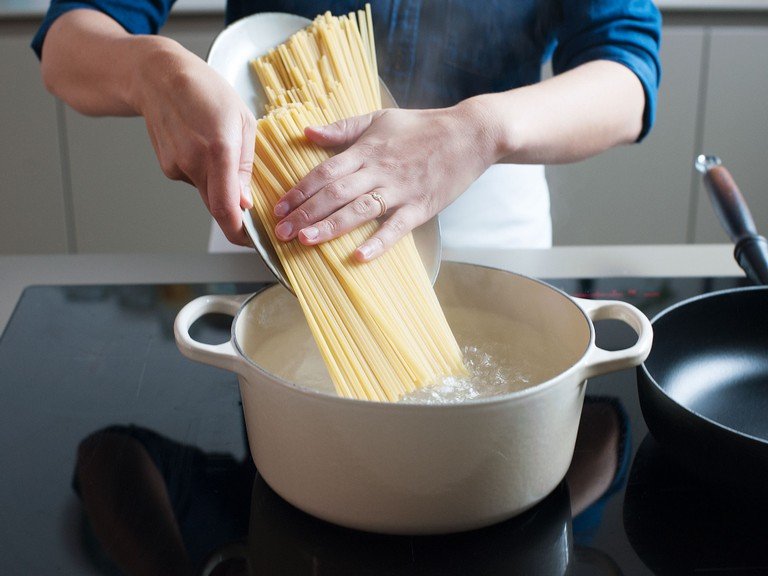 Grate cheese. Cook pasta in a large pot of salted boiling water until al dente, according to package instructions.