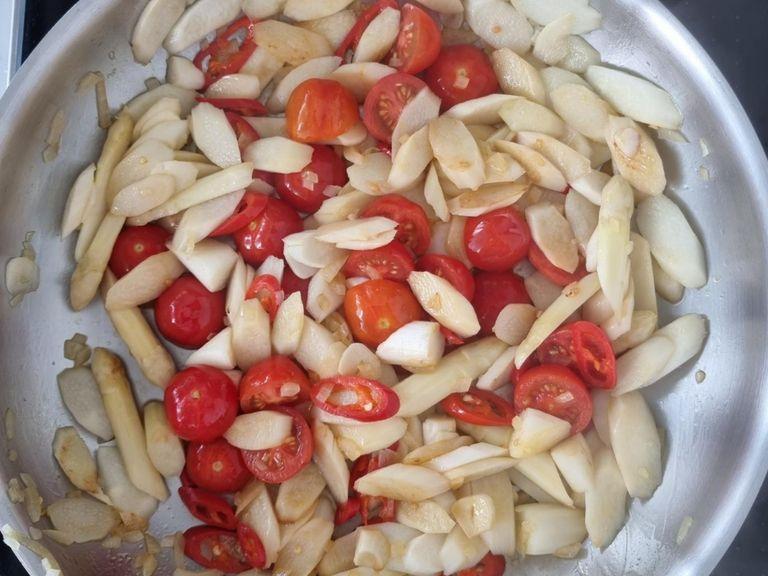 Put on the pasta water. Heat olive oil in a pan. Then sauté the asparagus for 1 min. Then add the chili peppers, onion and garlic and sauté for 5 min. Now add the cherry tomatoes and deglaze with the juice of half a lemon.