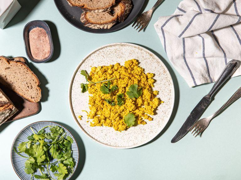 Serve tofu scramble with finely chopped green herbs of choice, like cilantro, and some fresh bread.