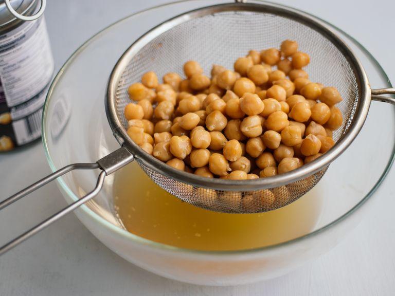 Place a fine sieve over a bowl. Open a can of chickpeas and drain through the sieve. The liquid that will be saved in the bowl is aquafaba. You should get approx. 7 tbsp of it with one smaller can of chickpeas.