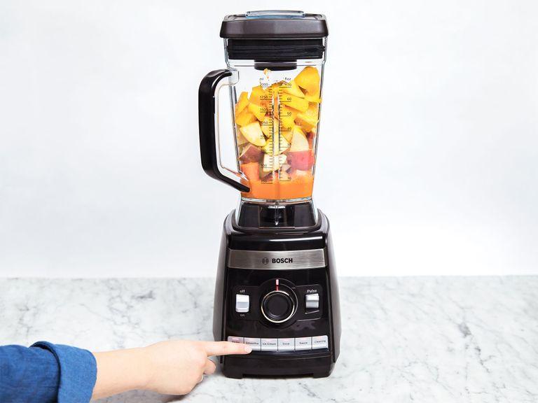 Peel the orange, ginger, and carrots, core the apples, then roughly chop them all. Add them to the blender. Juice lemon. Add mangoes, lemon juice, flaxseed oil, ground turmeric, and carrot juice to the blender and blend until smooth (using your blender's smoothie function).