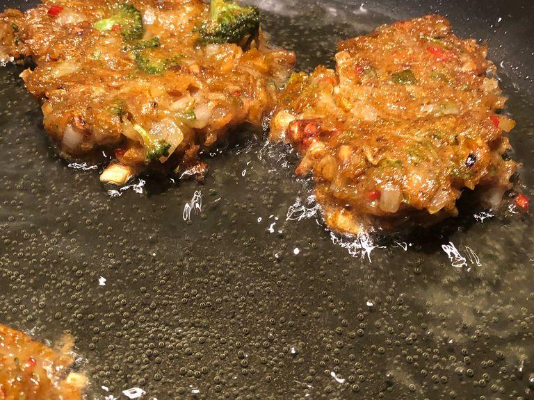 Add about 1cm of veg oil to a pan and heat. Add about 1 and a half tablespoons of the mix per burger and fry evening on each side. Each side should take 1-2 minutes.