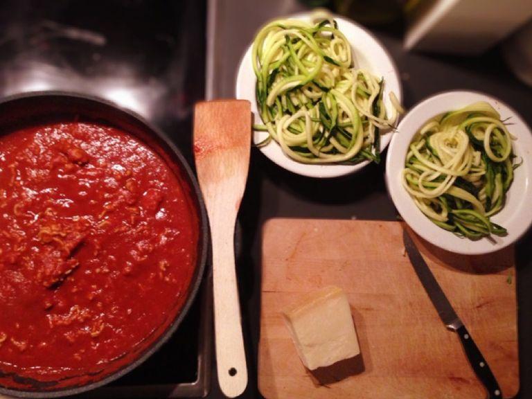 Drain zoodles and add to serving plates with Bolognese sauce the rest of the Parmesan. Stir well. Serve with fresh basil.