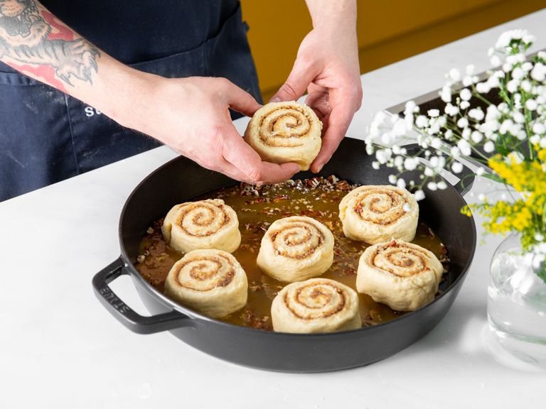 Roll up the dough and slice into 10 - 12 pieces. Add them to the baking dish on top of the caramel, making sure to leave room in between. Cover and let rise for approx. 45 min.