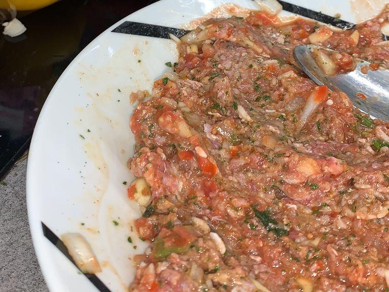 Chop your onion and garlic, wet your rice and set it aside. Blend 1 tomato , mix it with the tomato sauce and add only half of it to the minced beef. Make the rest of the filling by adding the following to the minced beef. Then mix everything until all is combined.