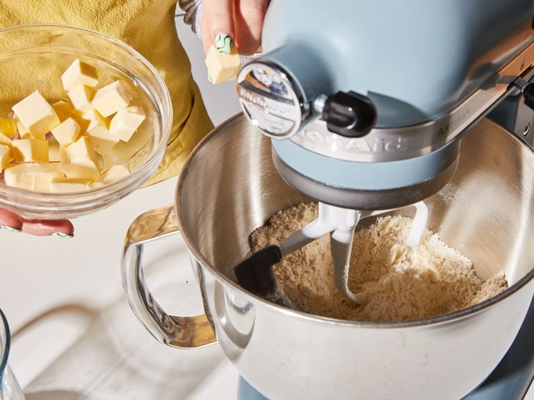 For the pastry, combine flour, confectioner’s sugar, and salt and add to the bowl of a stand mixer fitted with a paddle attachment. Add ⅔ of the cold, cubed butter and mix on medium until you have a coarse sandy mixture. Slowly stream in the ice water and mix on medium-high for approx. 1 min., until the mixture comes together as a ball and forms a dough. Flatten the dough into a disc, cover with plastic wrap, transfer to the refrigerator, and let chill for approx. 2 hrs.