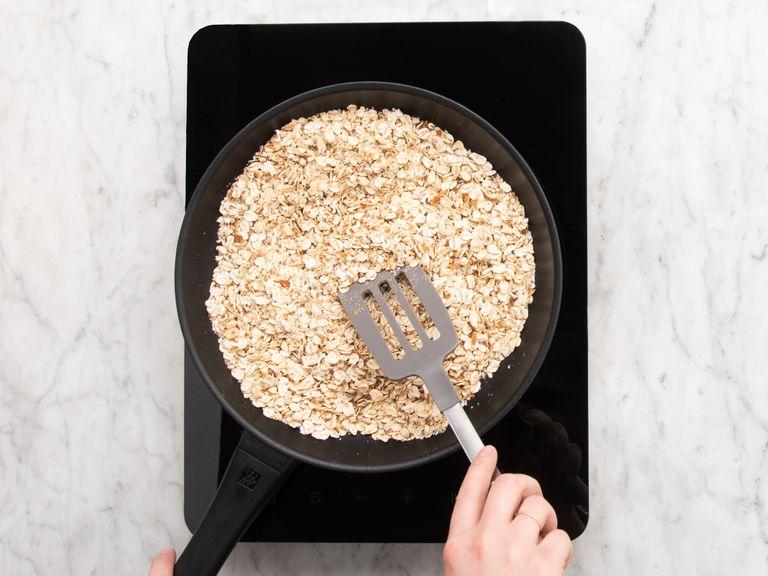 Chop almonds and add to a frying pan on medium-low heat. Add rolled oats and roast for approx. 10 min., or until the almonds are fragrant. Remove from heat and set aside.