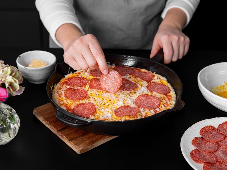 Den Pizzateig mit der Hälfte der Tomatensoße, des Käses und der Peperoni-Salami belegen. Im vorgeheizten Ofen bei 250°C ca. 10 Min. backen.
Aus dem Ofen nehmen und sofort servieren. Mit den restlichen Zutaten ein zweites Mal wiederholen. Guten Appetit!