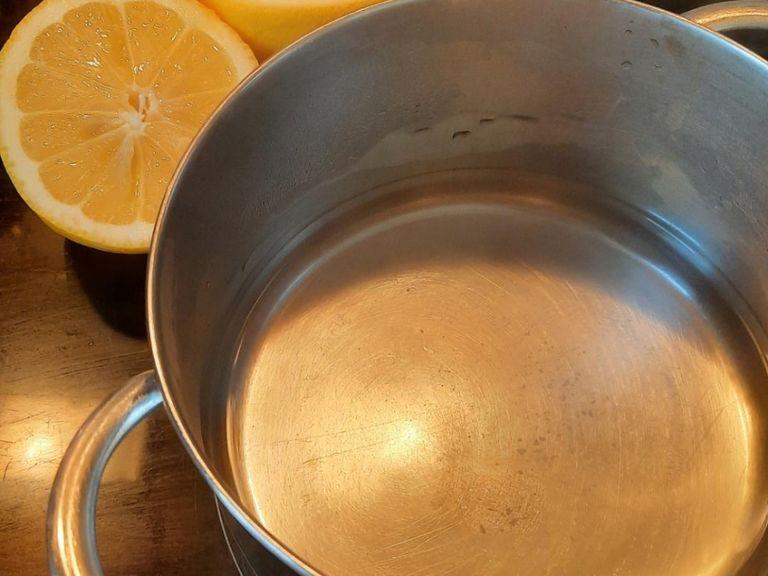 Juice lemons. Add to a pot along with the water and bring to a boil.