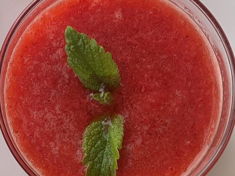 Mix strawberries with powdered sugar in a blender. Decorate with mint.