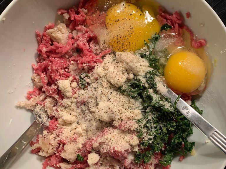 Add minced meet, eggs, minced garlic, grated Parmesan cheese, ground pepper and finely cut parsley to the soften breadcrumb.