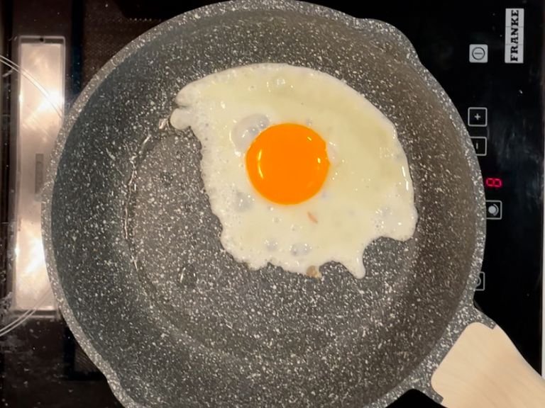 For the fried egg, Heat about vegetable oil in a small non-stick pan or a wok over medium high heat. Once the oil is hot, crack the egg directly into the wok and let it fry until the edges are browned and bubbly. Then remove and set aside.