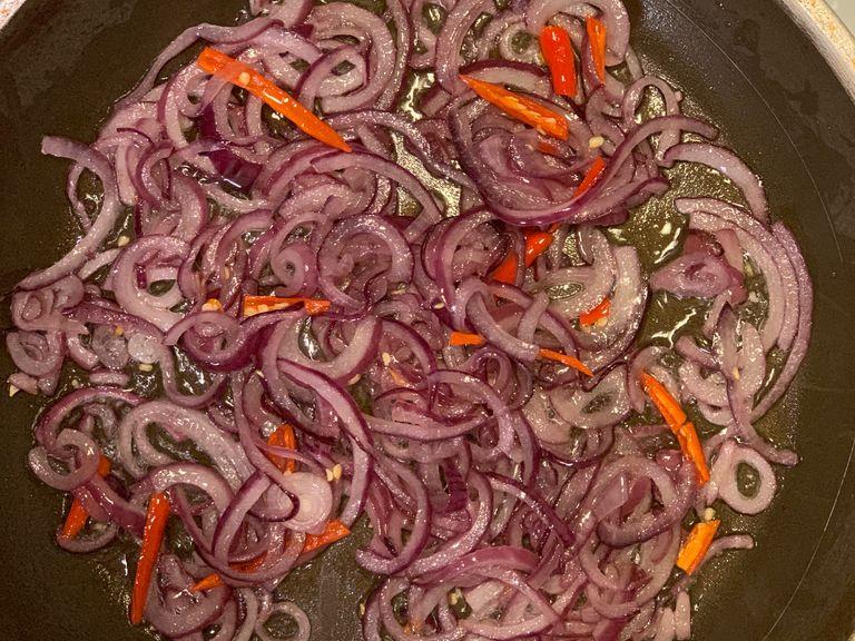 Add the chilli when the onions turn almost yellowish and sauté for a while.