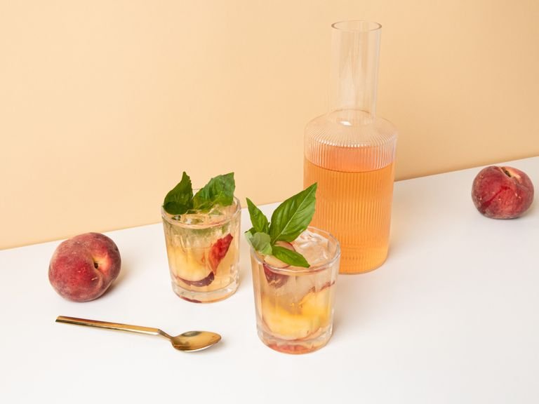 Rosé spritzer with white peaches and basil