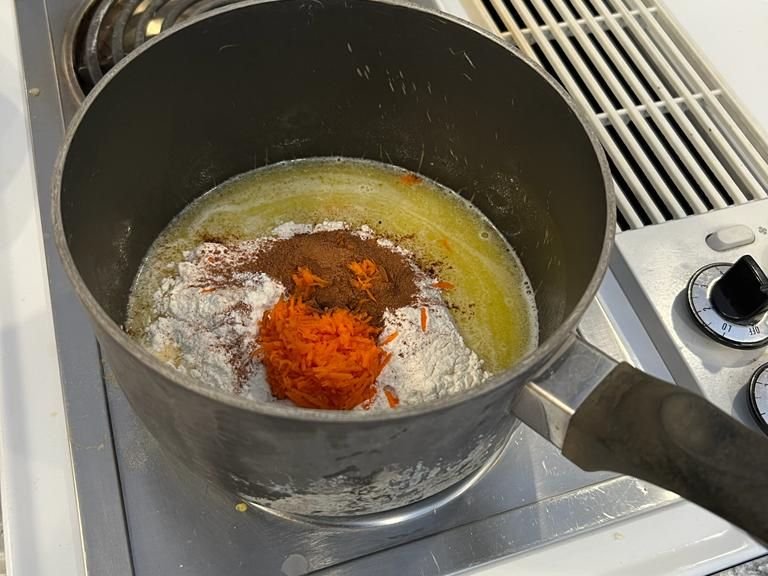 Take the pan off the heat and combine flour, your spices, and carrots into the pan mixture. Put back on the heat and cook for 1-3 more minutes while mixing constantly.