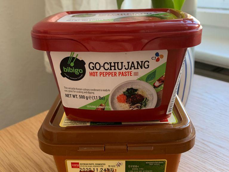 When the soup is boiling, add fermented bean paste (Korean doenjang) and gochujang. Stir to combine. Add bok choy leaves and garlic, cover with lid, let simmer for 10 minutes.