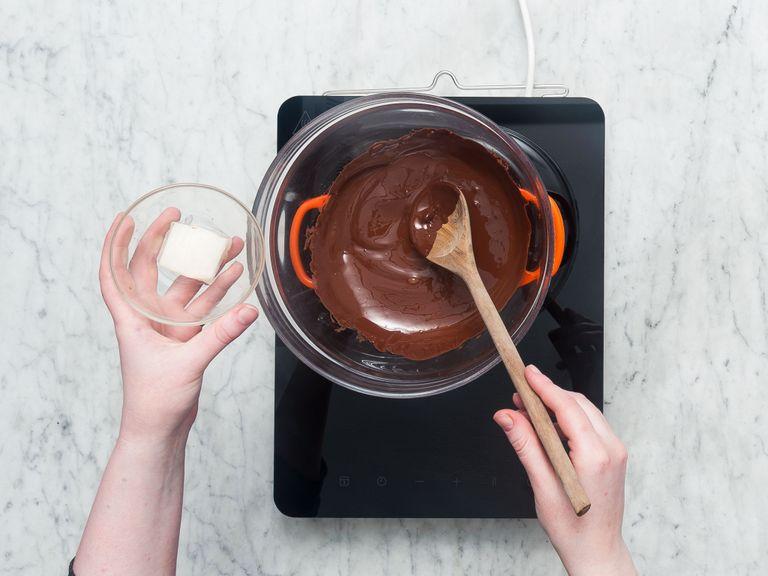 Chop chocolate. Set up a double boiler by placing a heat-proof bowl over a saucepan of simmering water. Melt chopped chocolate in heat-proof bowl and stir in coconut oil. Remove from heat and let cool until lukewarm.
