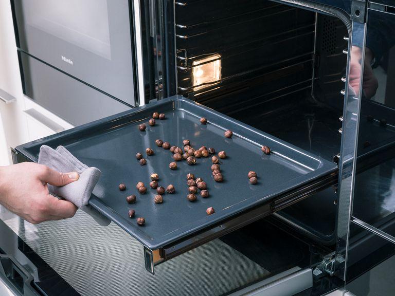 Preheat oven to 200°C/390°F. Transfer hazelnuts onto a baking sheet and roast in the oven for approx. 5 min. or until fragrant and brown. Remove from oven and let cool until easy to handle. Rub hazelnuts between a kitchen towel to remove their skins. Roughly chop the peeled hazelnuts and set aside.
